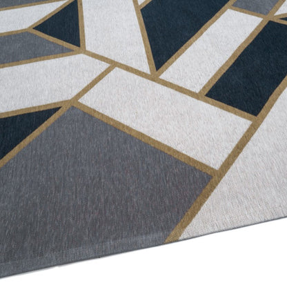 Close-up of a geometric patterned rug with blue, gray, and white colors.