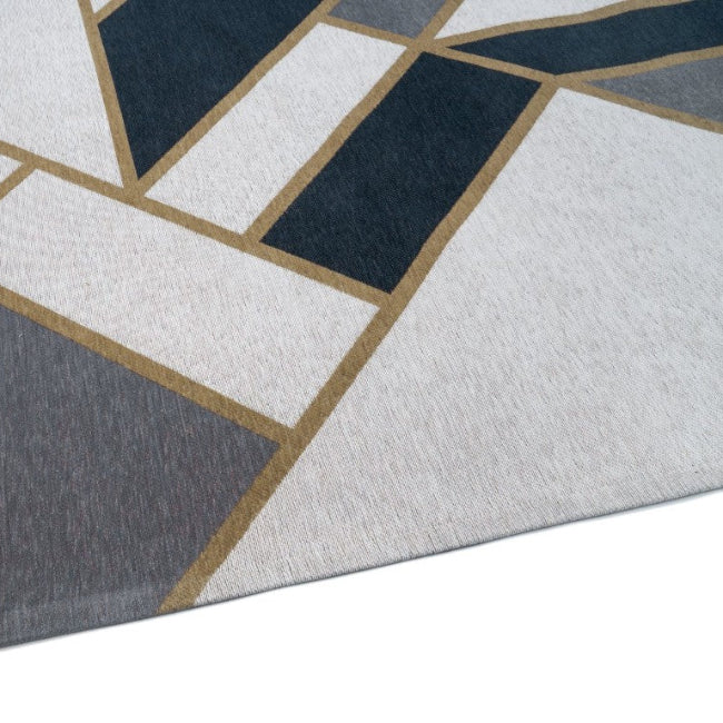 Close-up of a geometric patterned rug with blue, gray, and white colors.