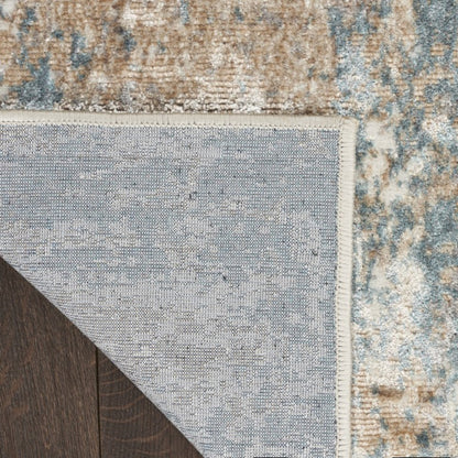 Close-up of a textured rug with a neutral color palette on a wooden floor.