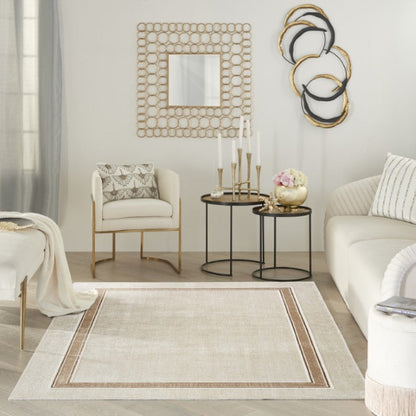 Modern living room with a beige rug, white sofa, and decorative wall art.