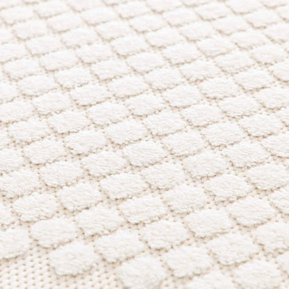 Close-up of a textured white fabric surface