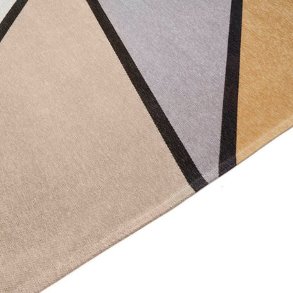 Close-up of a geometric patterned rug with beige, grey, and black colours.