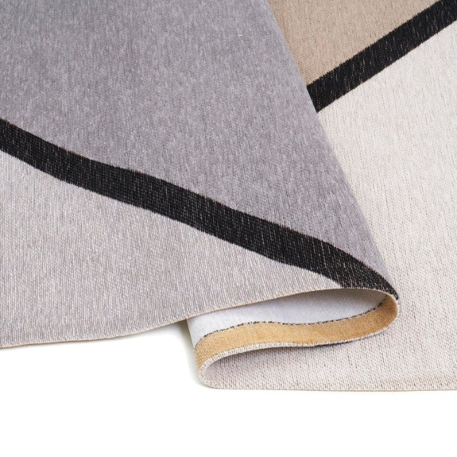 Close-up of a roll of wallpaper with a geometric pattern on a white background