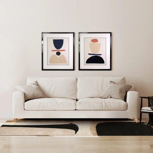 Modern living room with a white sofa, floor lamp, and abstract art on the wall.