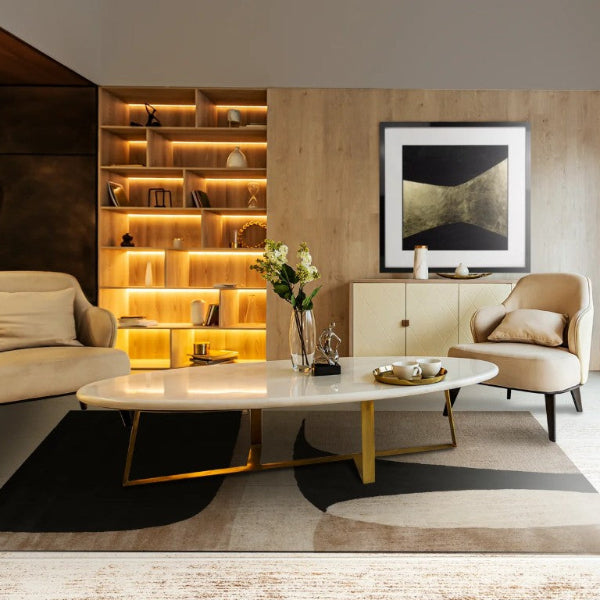 Modern living room with beige furniture, a coffee table, and decorative elements.