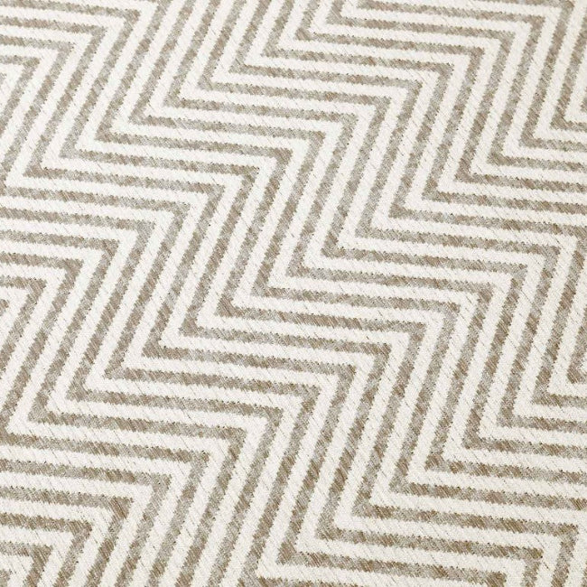 Patterned fabric with zigzag design in beige and brown tones.