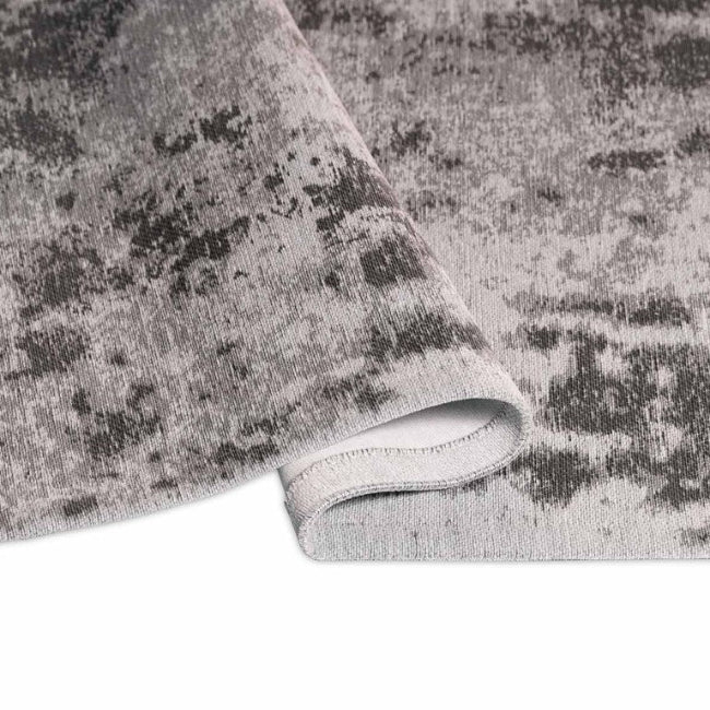 Gray textured rug with a pattern on a white background