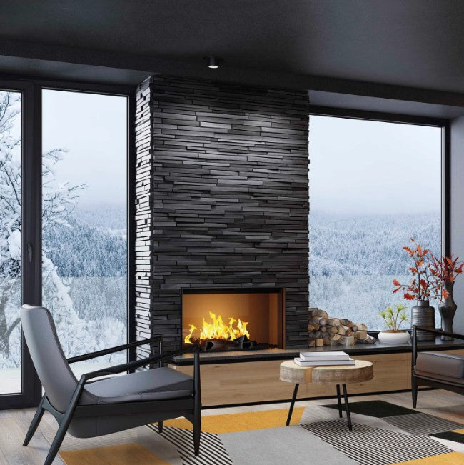 Modern living room with a fireplace and large windows showing a snowy landscape.