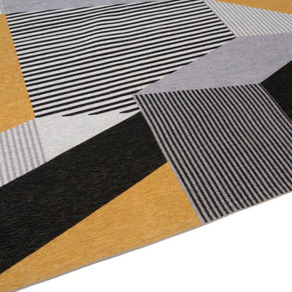 Geometric patterned rug with black, yellow, and gray colors on a white background