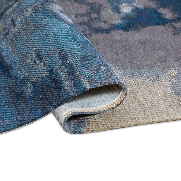 Blue and gray patterned rug on a white background