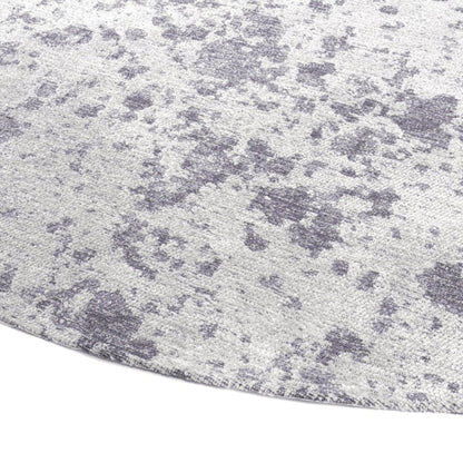 Close-up of a textured grey rug with a subtle pattern like the surface of the moon