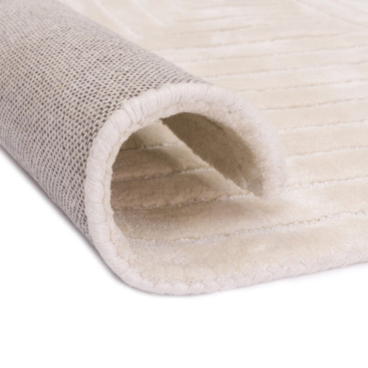 Close-up of a beige carpet roll on a white background