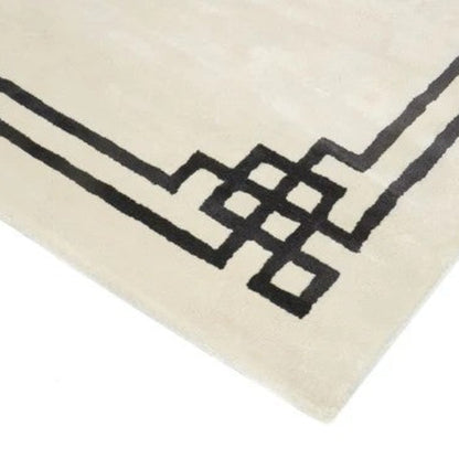 Close-up of a beige rug with black geometric patterns