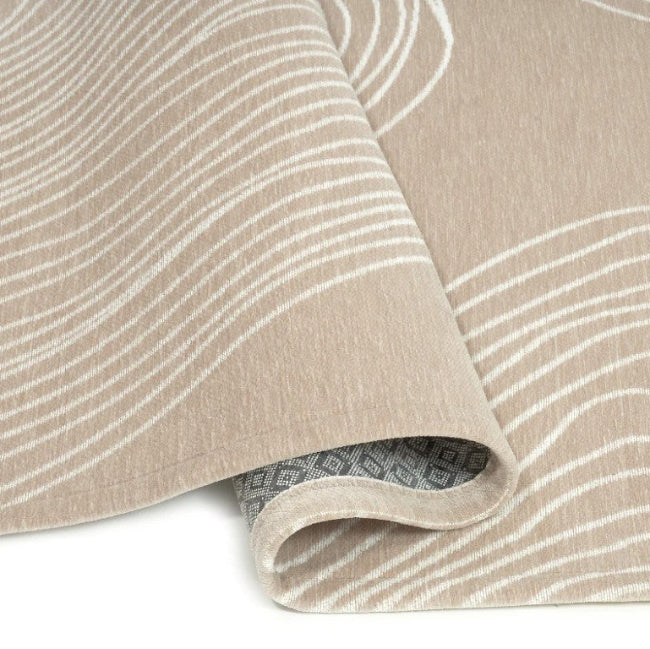 Beige fabric with white wavy lines on a beige background