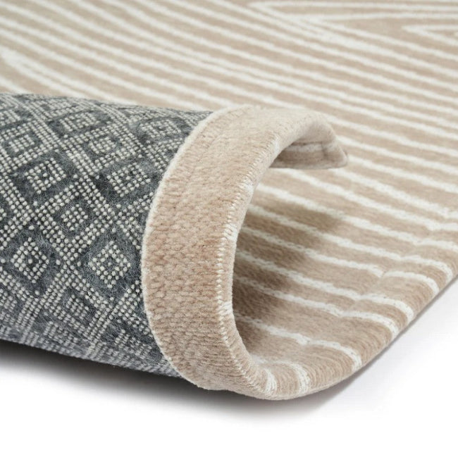 Two rolled-up rugs, one with a geometric pattern and the other with stripes, on a white background.