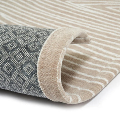 Two rolled-up rugs, one with a geometric pattern and the other with stripes, on a white background.