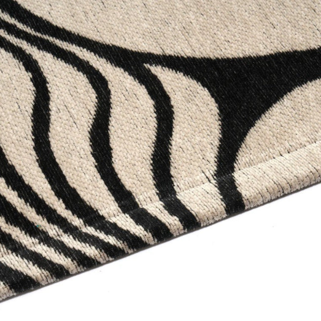 Close-up of a zebra-patterned rug with black and white stripes.