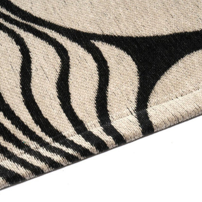 Close-up of a zebra-patterned rug with black and white stripes.