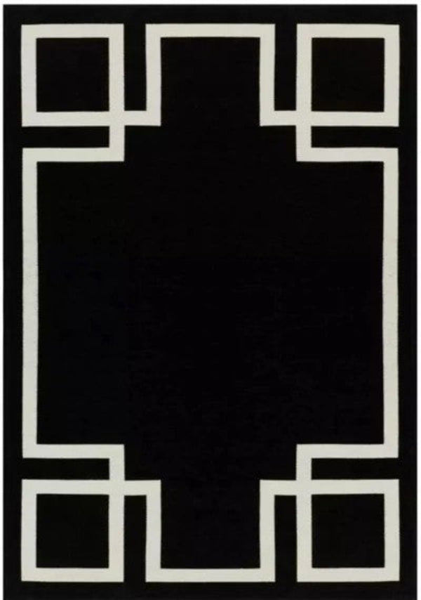 Black rug with white geometric border design