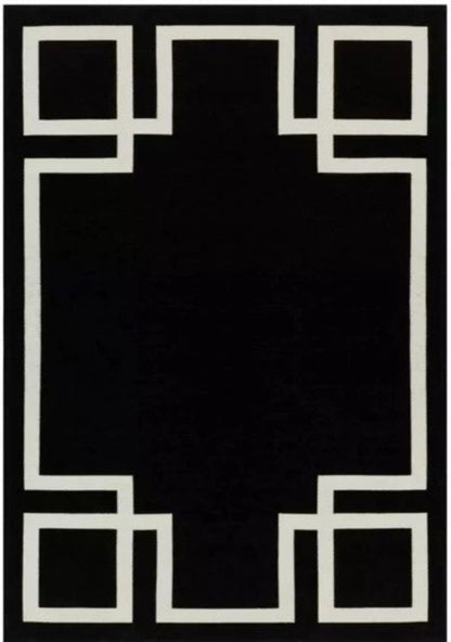 Black rug with white geometric border design