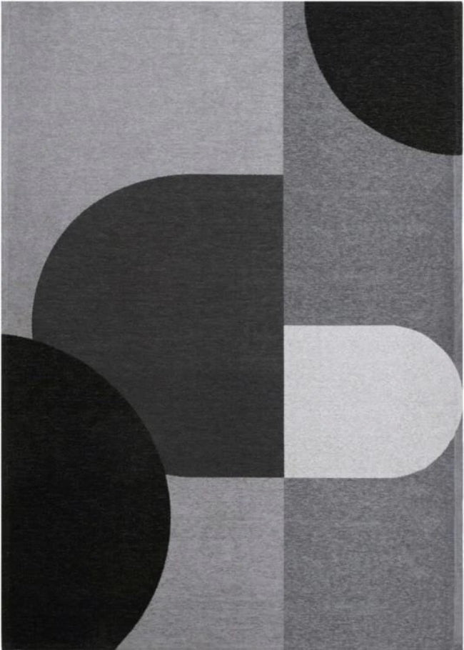 Rug with abstract pattern of black, gray, and white shapes