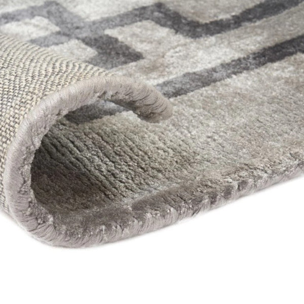 Gray patterned rug with a textured surface on a white background