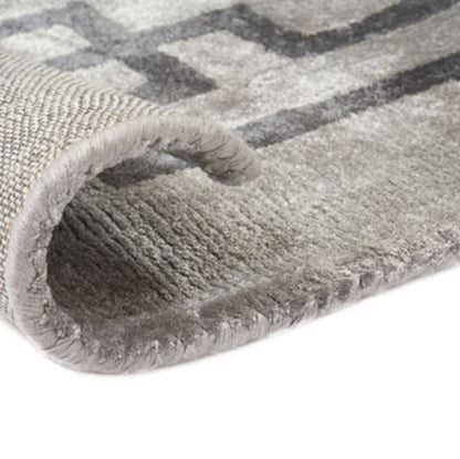 Gray patterned rug with a textured surface on a white background