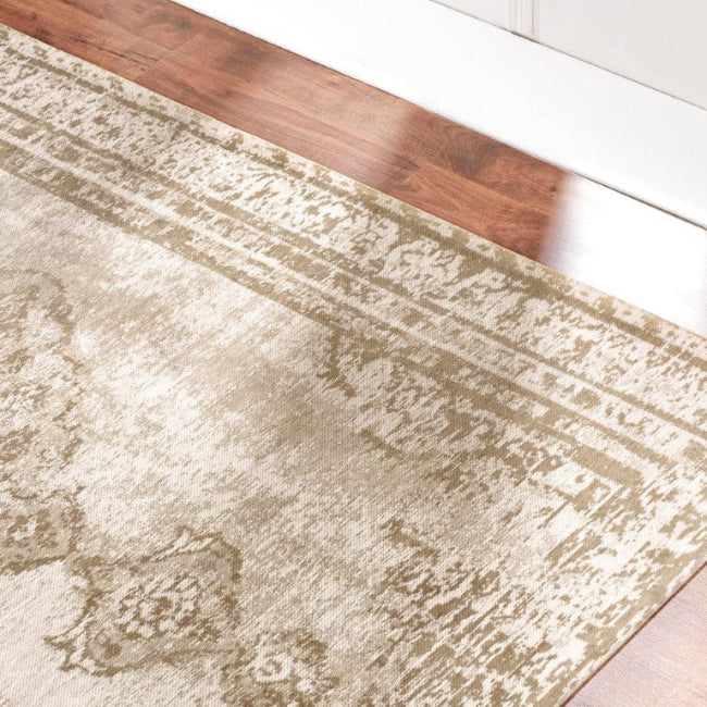 Beige area rug on a wooden floor