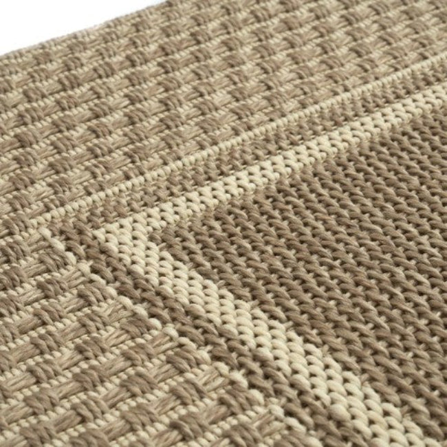 Close-up of a woven textured fabric with a geometric pattern.