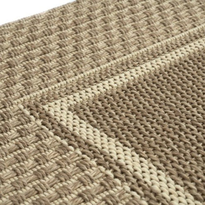 Close-up of a woven textured fabric with a geometric pattern.