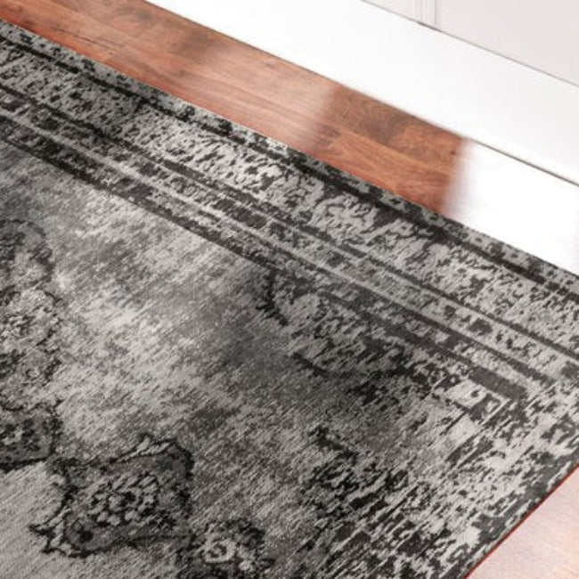 Grey patterned rug on a wooden floor