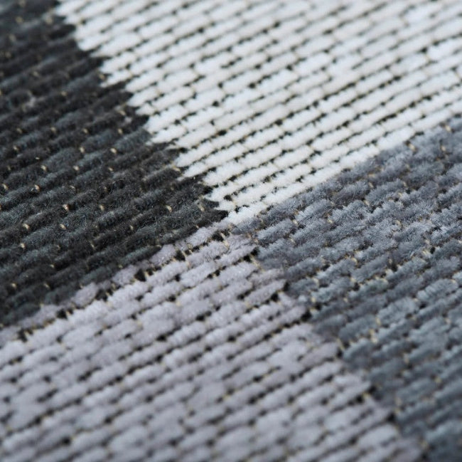 Close-up of a textured fabric with black, gray, and white pattern