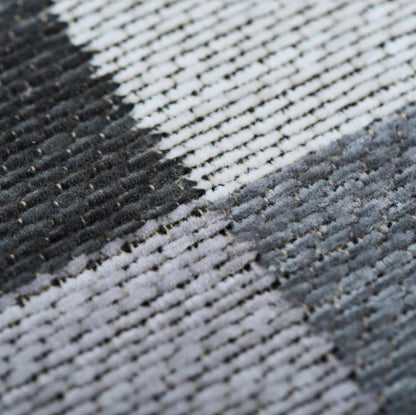 Close-up of a textured fabric with black, gray, and white pattern