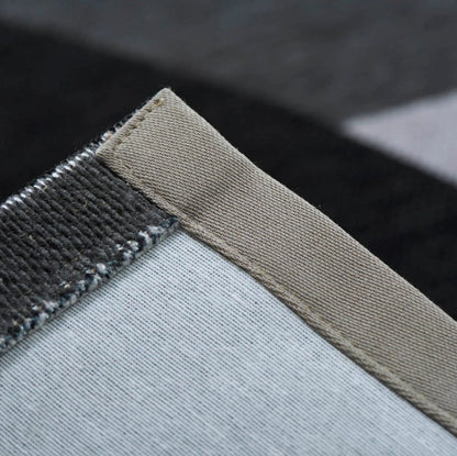 Close-up of a textured fabric edge with a neutral color palette.
