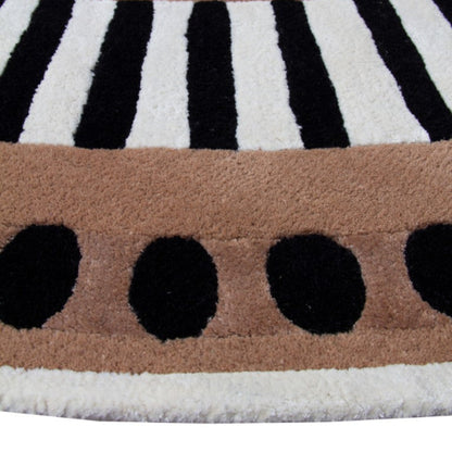 Close-up of a patterned rug with black, white, and brown colors.