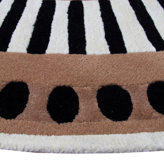 Close-up of a patterned rug with black, white, and brown colors.