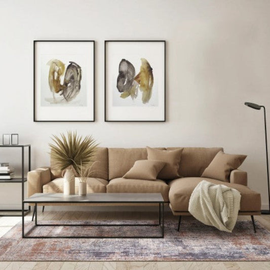 Modern living room with a beige sectional sofa, coffee table, and wall art.