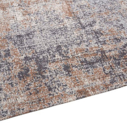 Textured area rug with a pattern of brown, gray, and beige on a white background