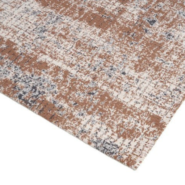 Close-up of a textured area rug with a checkered pattern in brown, beige, and black.