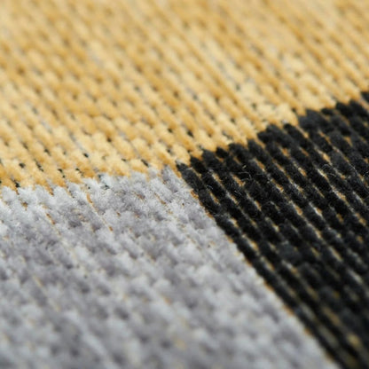 Close-up of a textured fabric with yellow, black, and gray pattern
