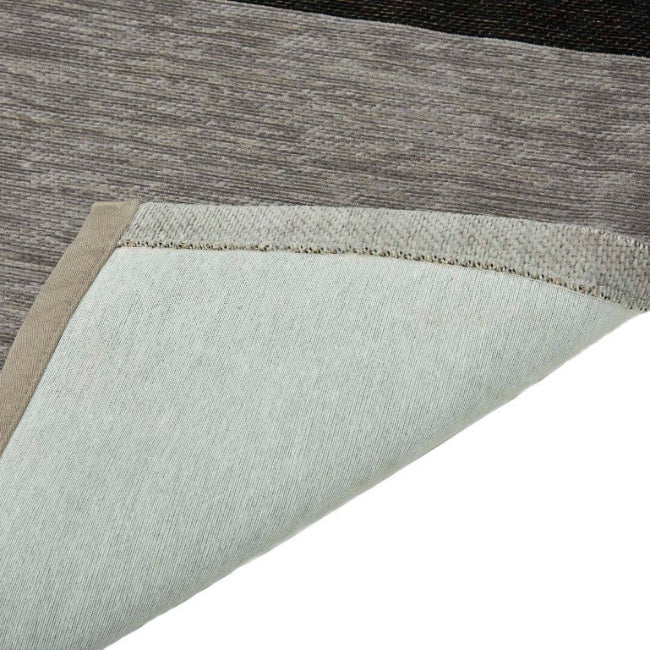 Close-up of a textured rug with a neutral color palette on a white background