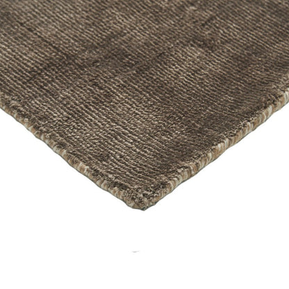 Close-up of a brown textured rug corner on a white background