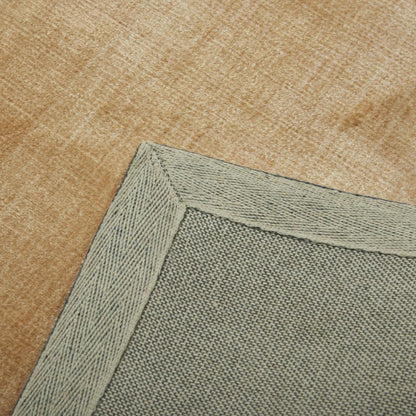 Close-up of a beige carpet with a green border