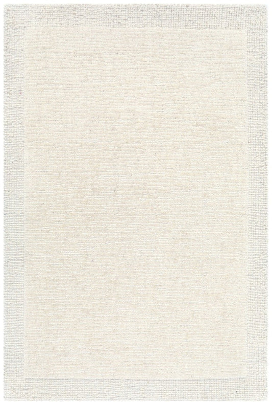 Beige area rug with a subtle pattern on a white background