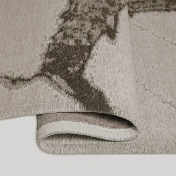 Close-up of a textured gray rug with a white background