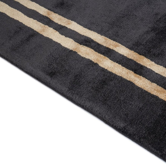 Black rug with gold stripes on a white background