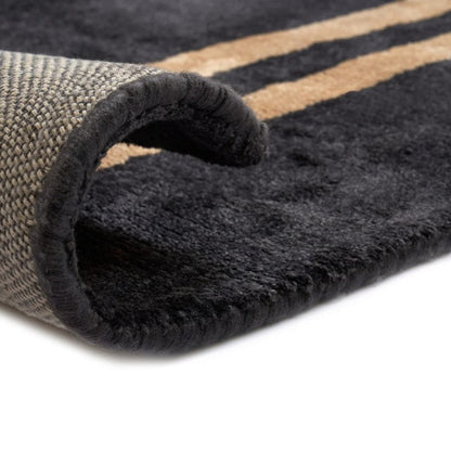 Close-up of a textured rug with a folded corner on a white background