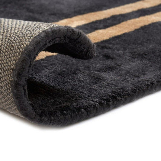 Close-up of a textured rug with a folded corner on a white background