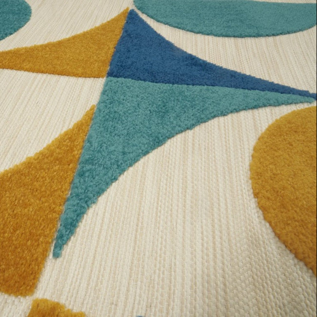 Close-up of a geometric patterned rug with blue, orange, and teal colors on a beige background.