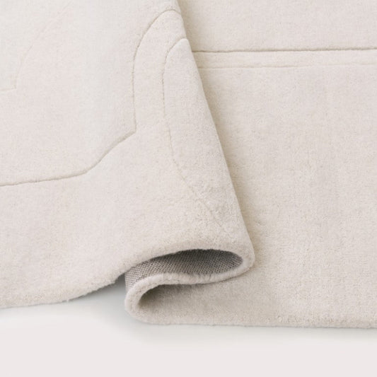 Close-up of beige fabric with a slight texture on a white background